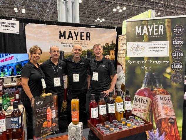 Gabor Oszter with the Mayer team at a trade show booth